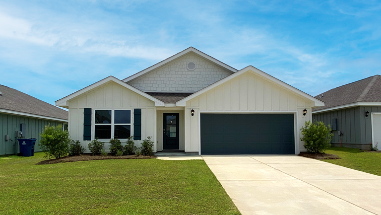 Single-story home with board and batten exterior and a two-car garage.