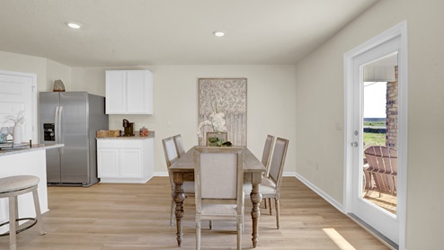 Shared kitchen and dining area with glass door leading to the back porch.