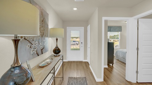 Entrance foyer with beautiful vinyl plank flooring connected to additional bedrooms and bathroom.
