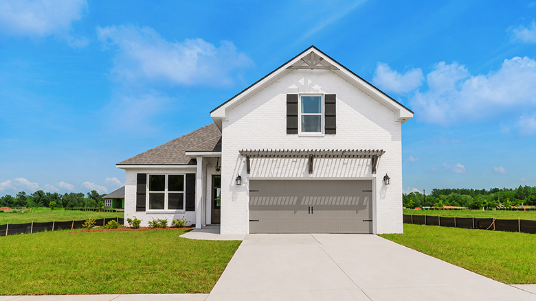 Two-story home with painted brick exterior and a two-car garage.