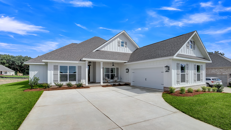 Single-story home with board and batten exterior and a side entry garage.