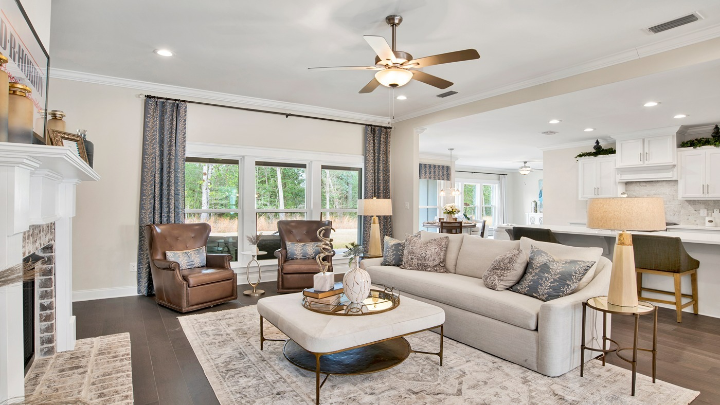 Living room with fireplace and large windows.