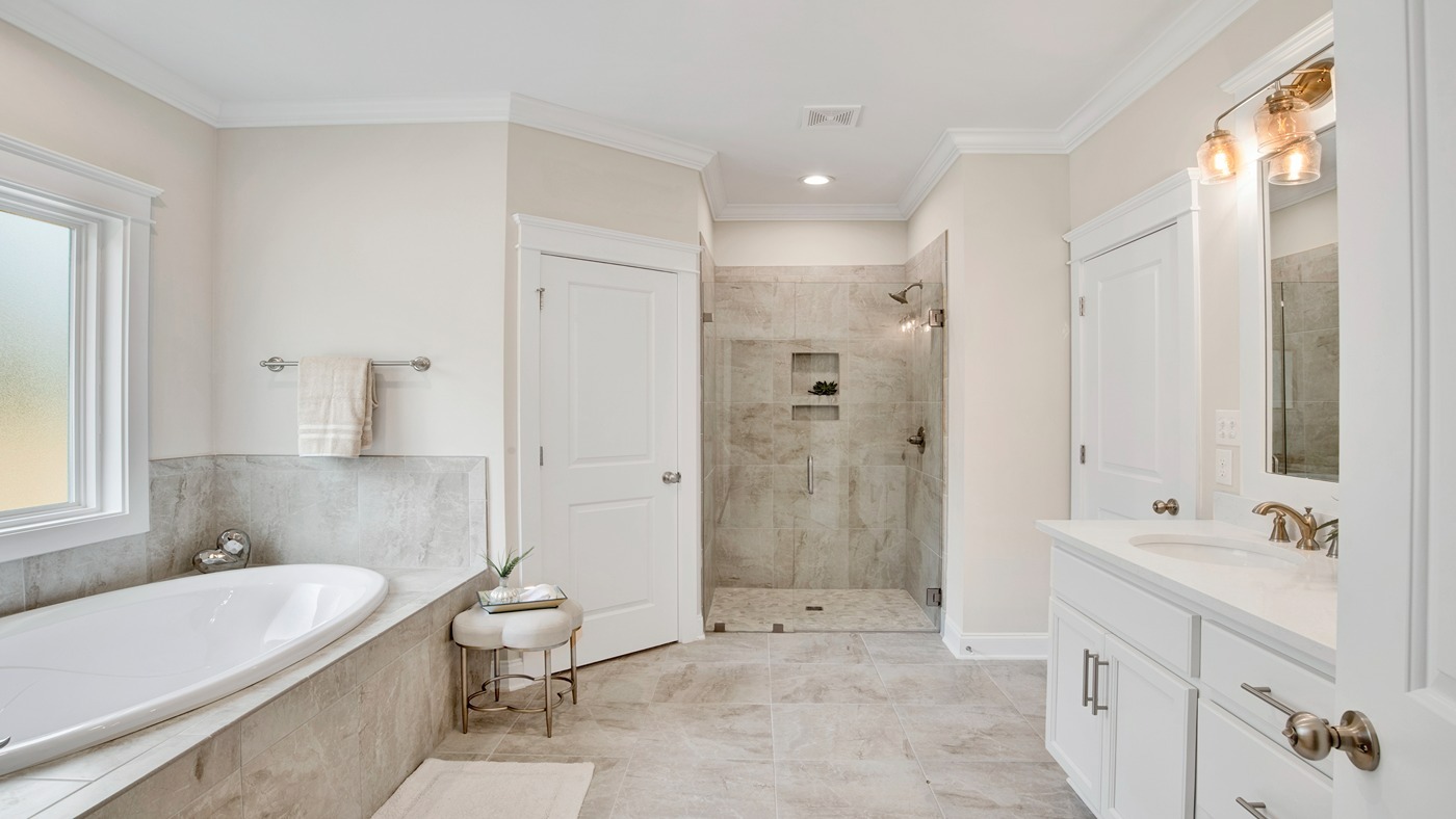 Luxurious primary bathroom with tub and separate shower.