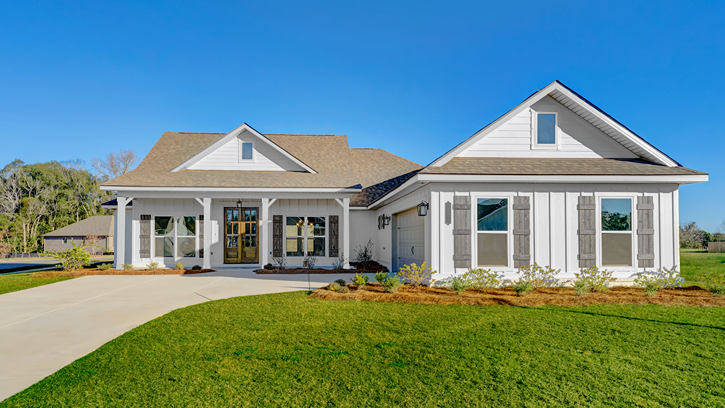 One-story new home with white exterior, gray shutters, and a two-car courtyard garage.