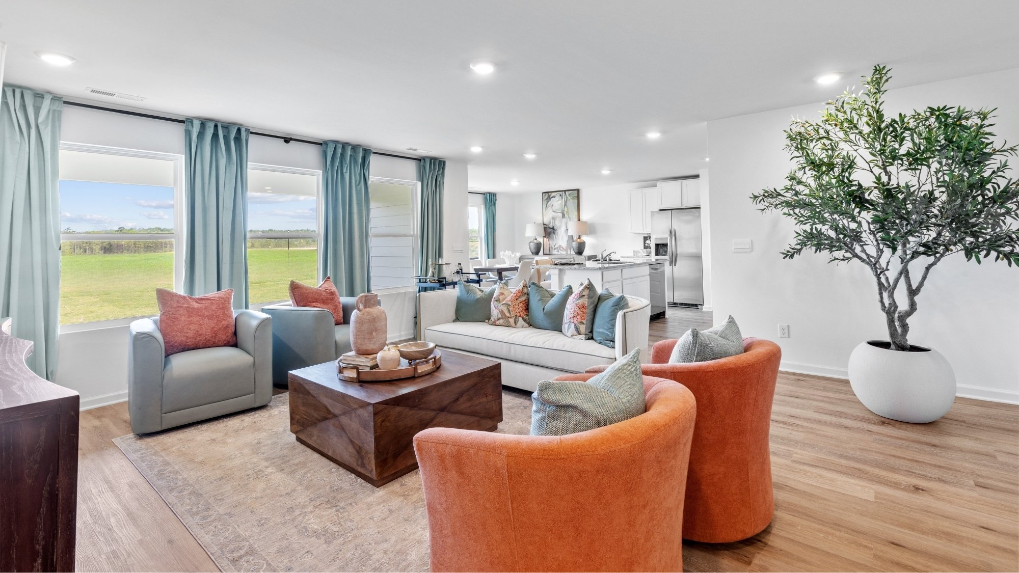 Open concept Cairn floorplan with connected living room, kitchen, and dining space.