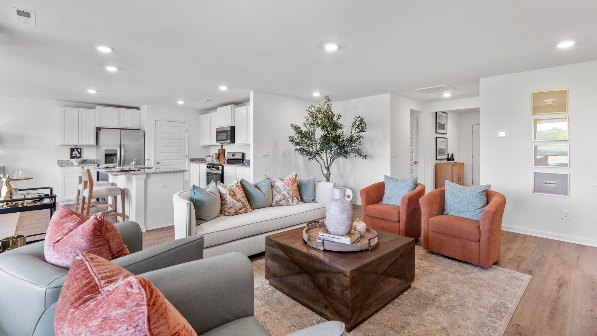 Open concept Cairn floorplan with connected living room, kitchen, and dining space.