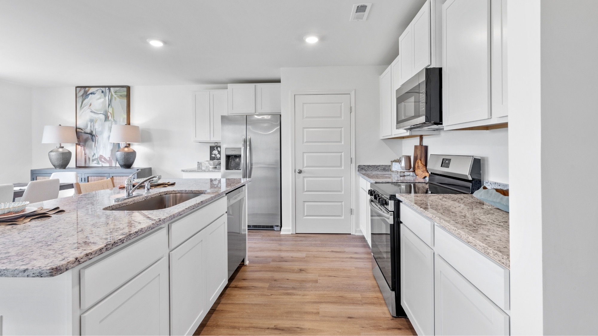 Open concept new home interior with 9-foot ceilings and vinyl flooring.
