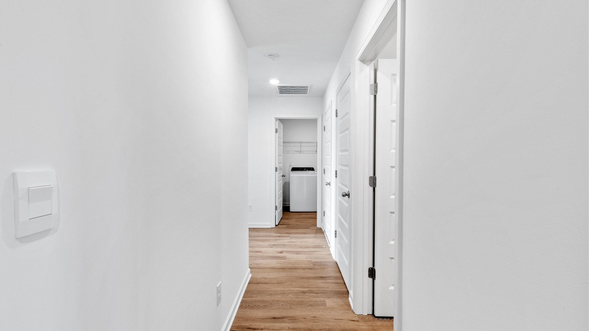 Open concept new home interior with 9-foot ceilings and vinyl flooring.