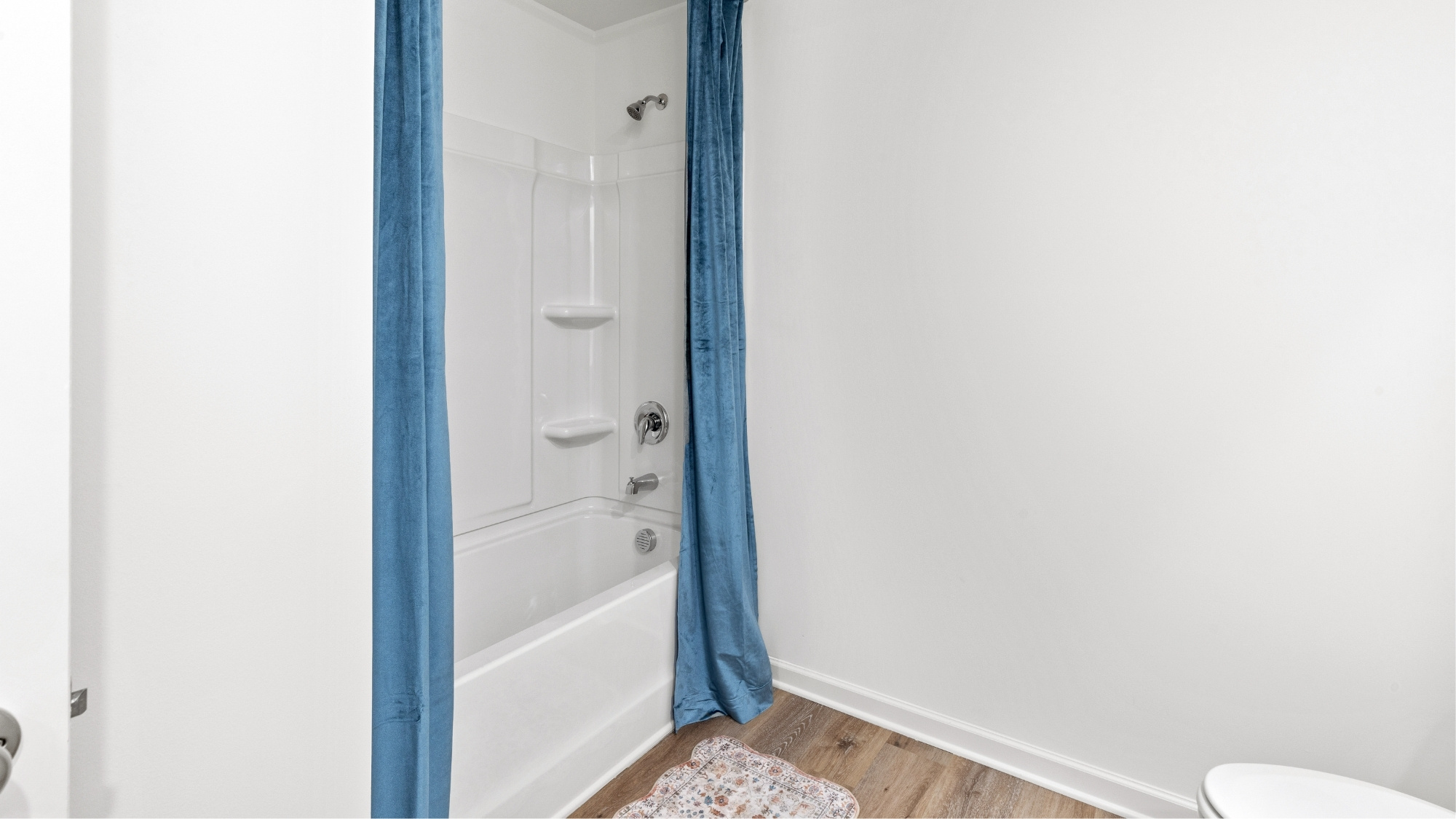 Spare bathroom with a shower/bathtub combination located towards the front of the home.