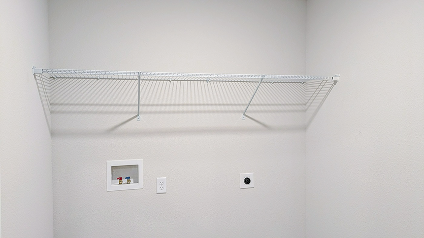 Laundry room with wire storage shelving.