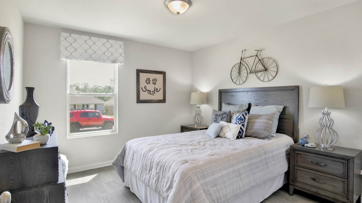 Spare bedroom with light-colored carpet.