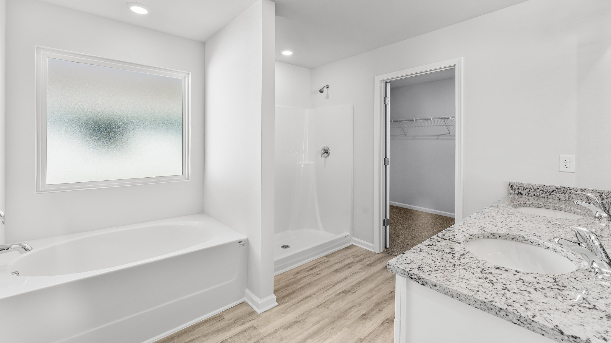 Primary bathroom with separate shower and 5-foot garden soaking tub.
