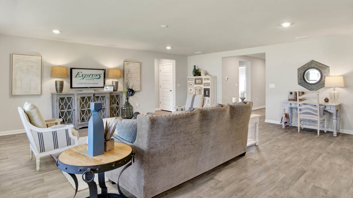 Open concept great room with 9-foot ceilings and vinyl flooring.