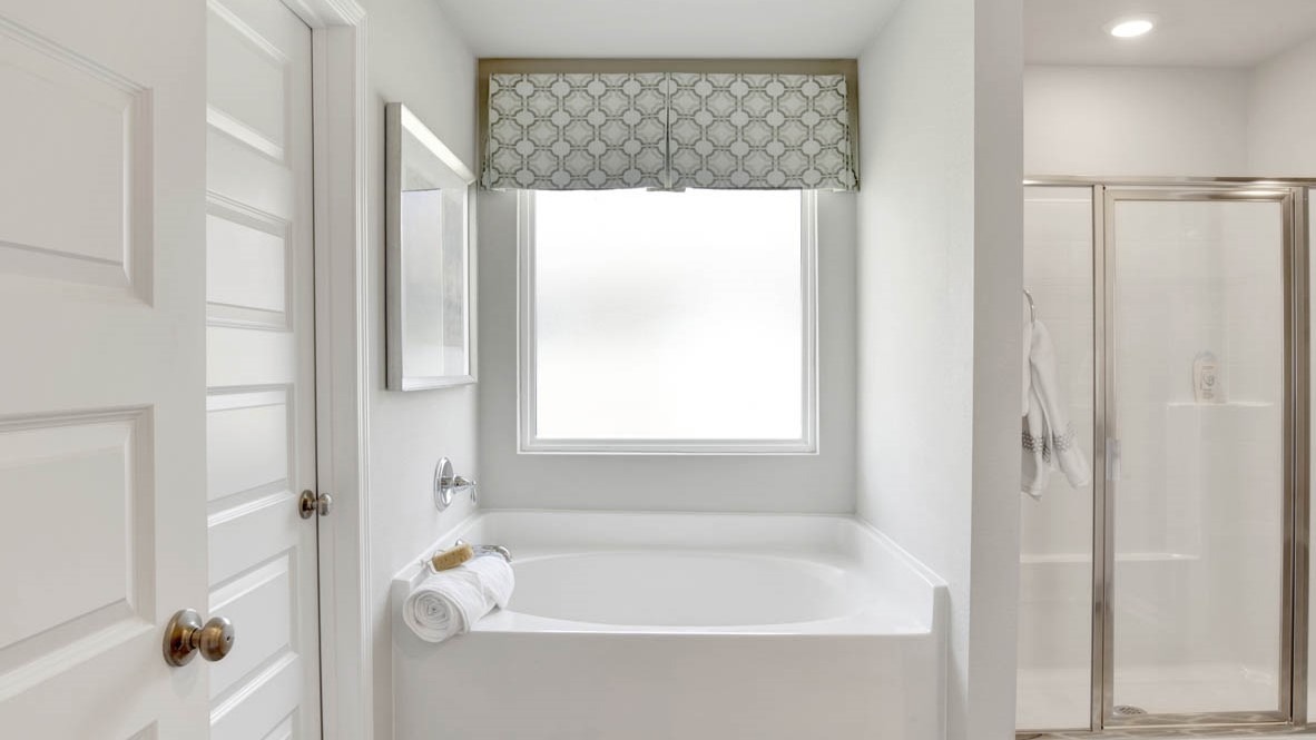 Primary bathroom with separate shower and 5-foot garden/soaking tub.