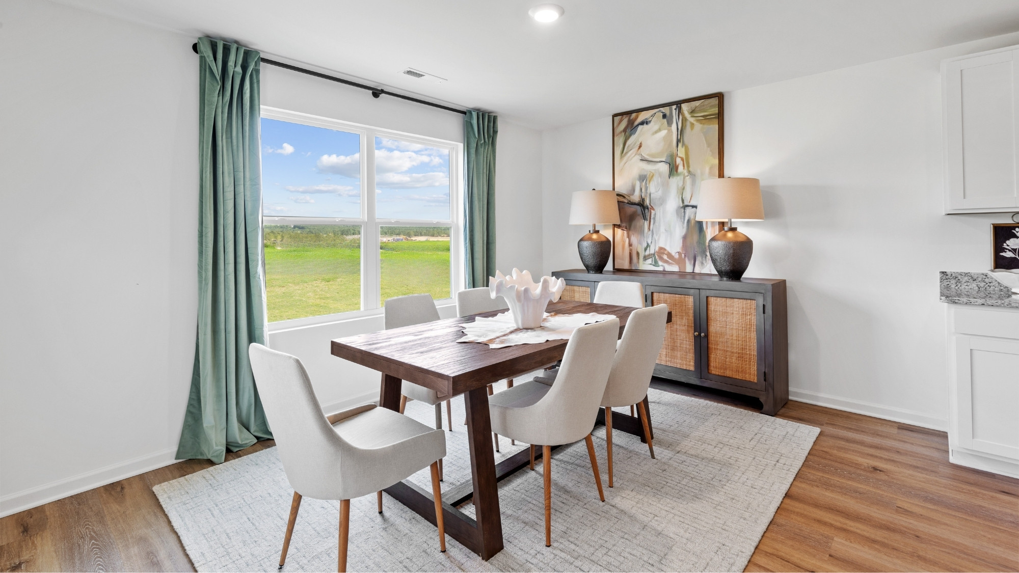 Dining room, connected off the kitchen, overlooking the backyard through a large window.