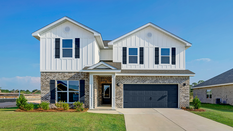 Two-story home with brick and board and batten exterior and a painted, two-car garage.