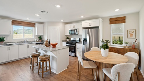 Open-concept kitchen with granite countertops and dining room