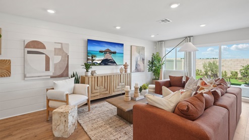 Open-concept great room with windows to rear yard