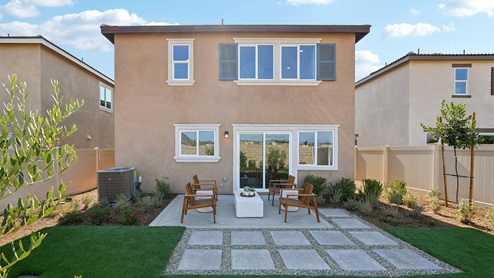 Spacious backyard with patio area and turf