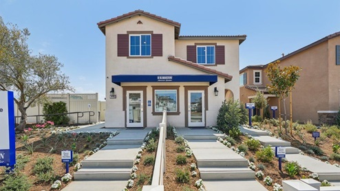 Two-story Spanish model home with shutters two-car garage