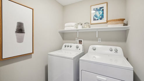Laundry room with washer and dyer with upper shelf