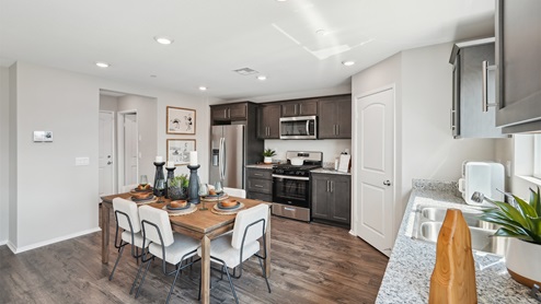Open-concept kitchen with granite counters and stainless steel appliances
