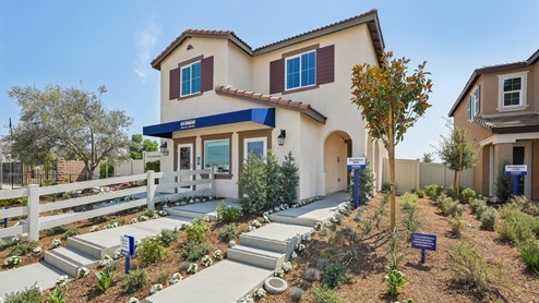 Two-story Spanish model home with shutters and two-car garage