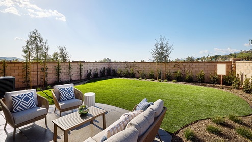 Spacious backyard with patio area and turf