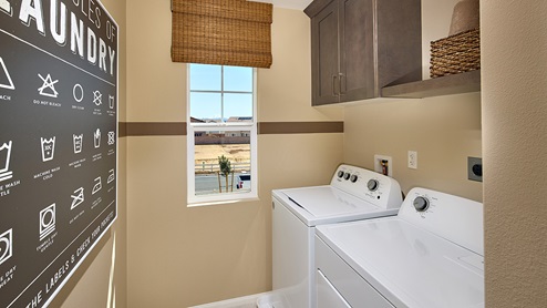 Laundry room with upper shelf and cabinet