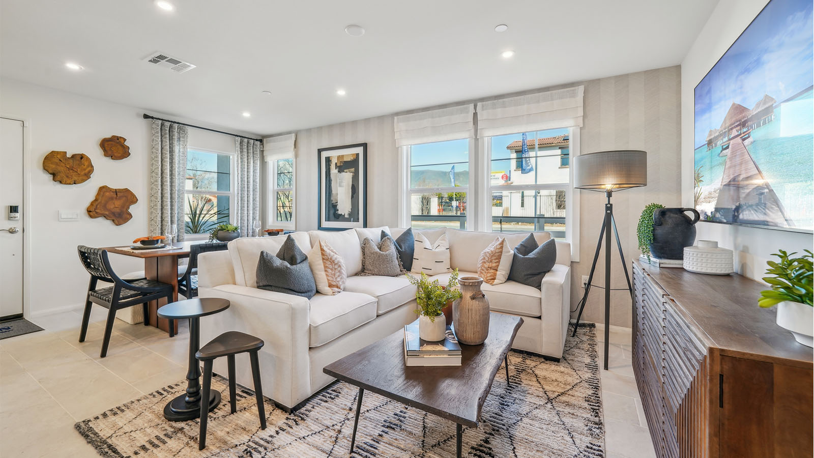 Open-concept dining and great room with accent wall