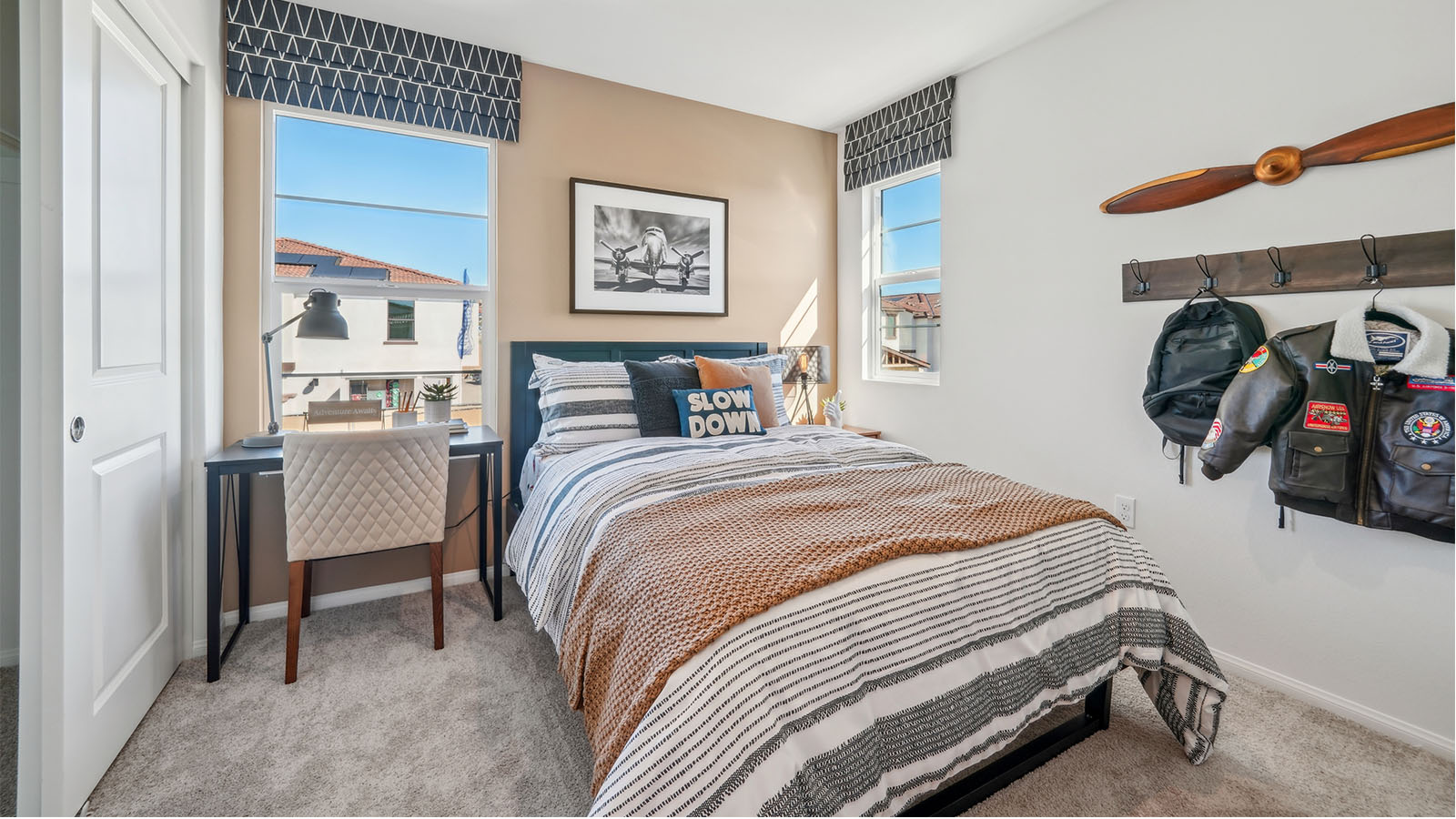 Bedroom with twin bed and plush carpet
