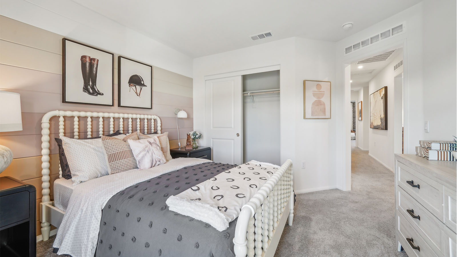 Bedroom with accent wall, full size bed, and plush carpet