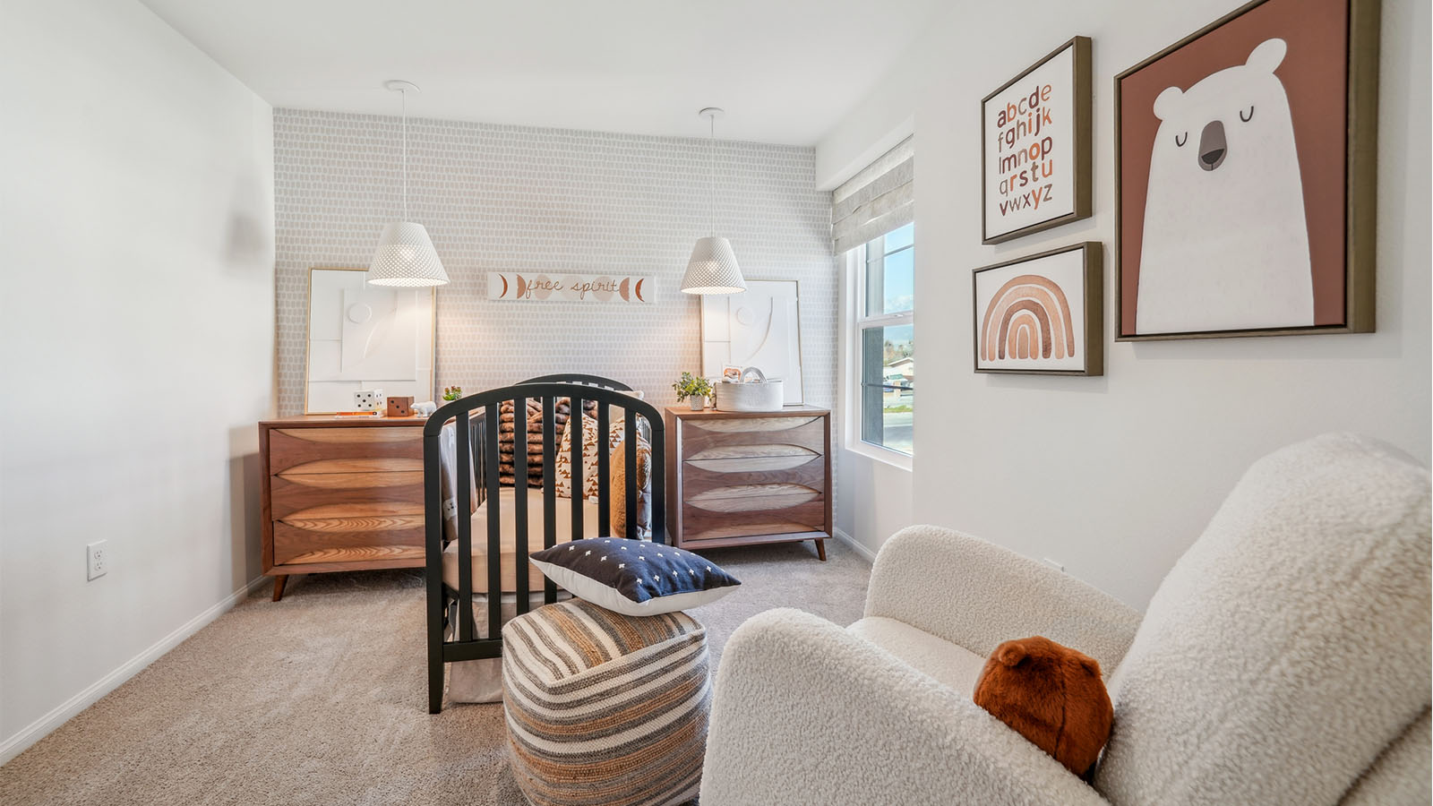 Beautiful nursery with accent wall and plush carpet