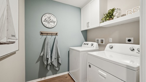 Laundry room with white upper cabinet and shelve