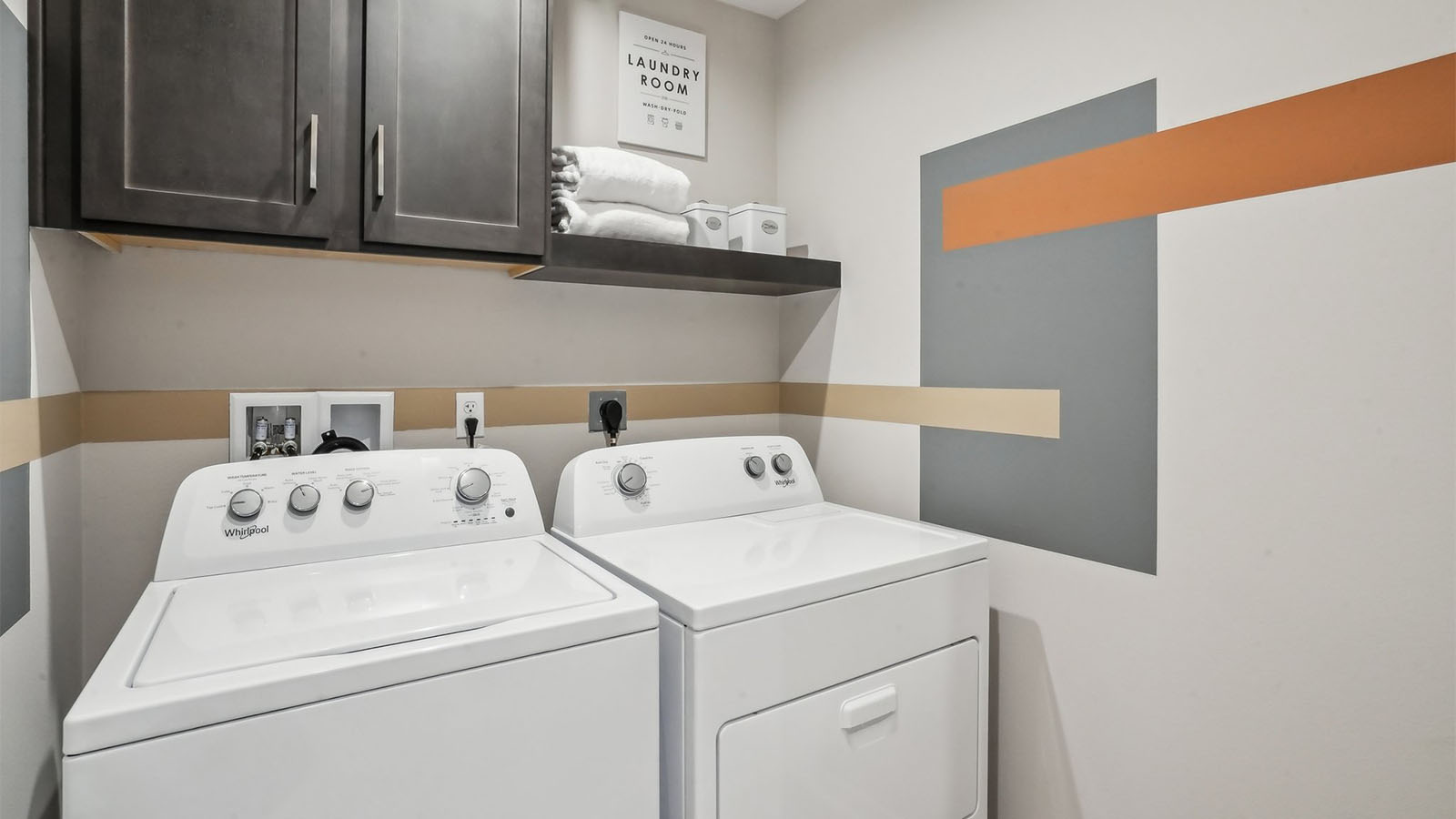 Laundry room with upper cabinet and shelf and washer and dryer