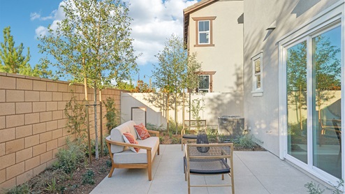 Spacious backyard with turf and patio furniture