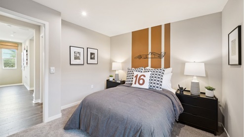 Secondary bedroom with paint accents, twin bed, and plush carpet
