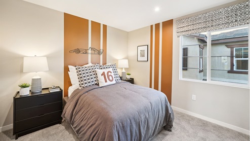 Secondary bedroom with paint accents, twin bed, and plush carpet