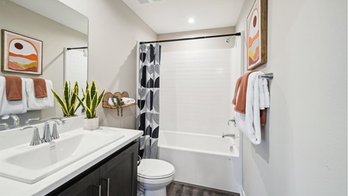 Primary bathroom with dual vanities and shower