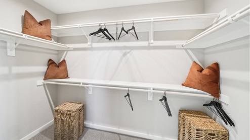 Spacious walk-in closet with shelving and poles
