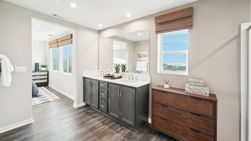 Spacious primary bathroom with laminate flooring