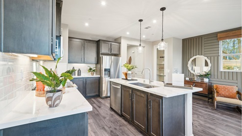 Open-concept kitchen with brown cabinets and quartz countertops