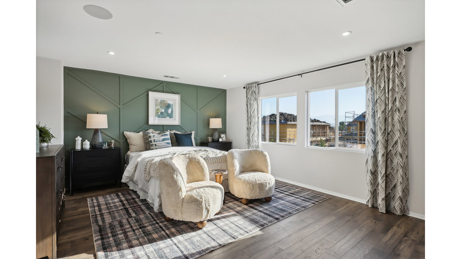 Primary bedroom with king bed and laminate flooring