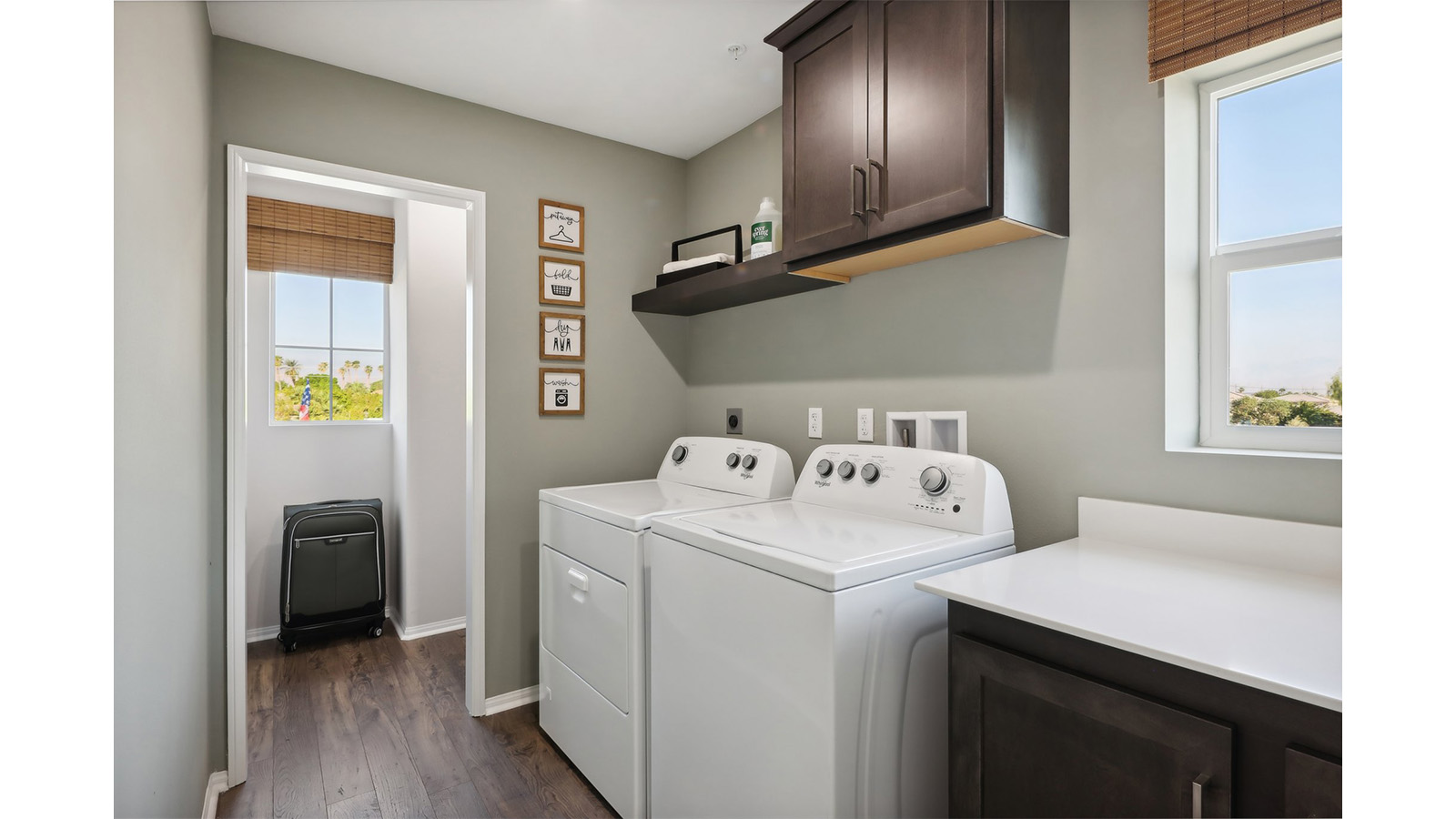 Laundry room with lower and upper cabinet and shelf and washer and dryer