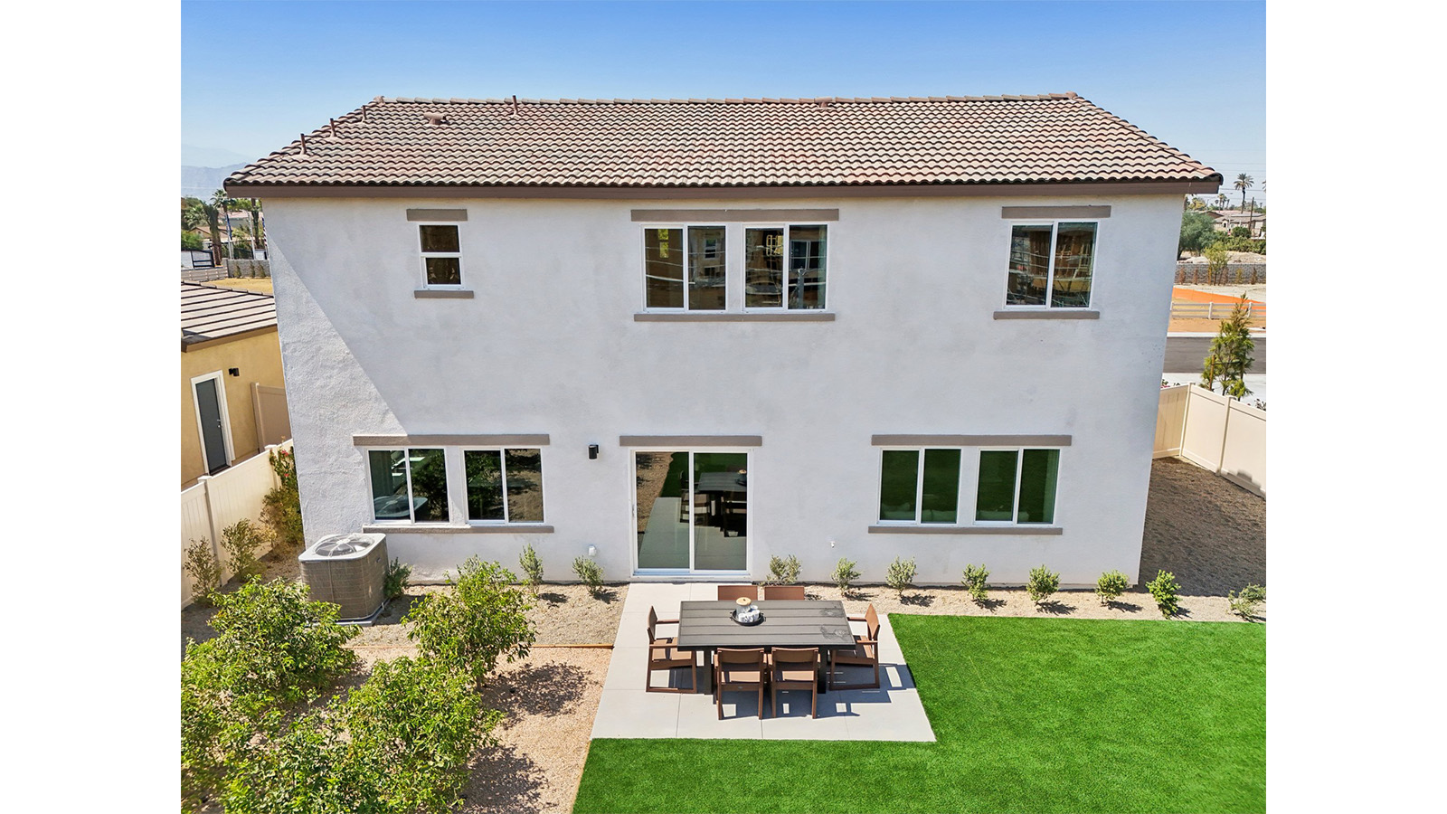 Spacious backyard with turf and patio area