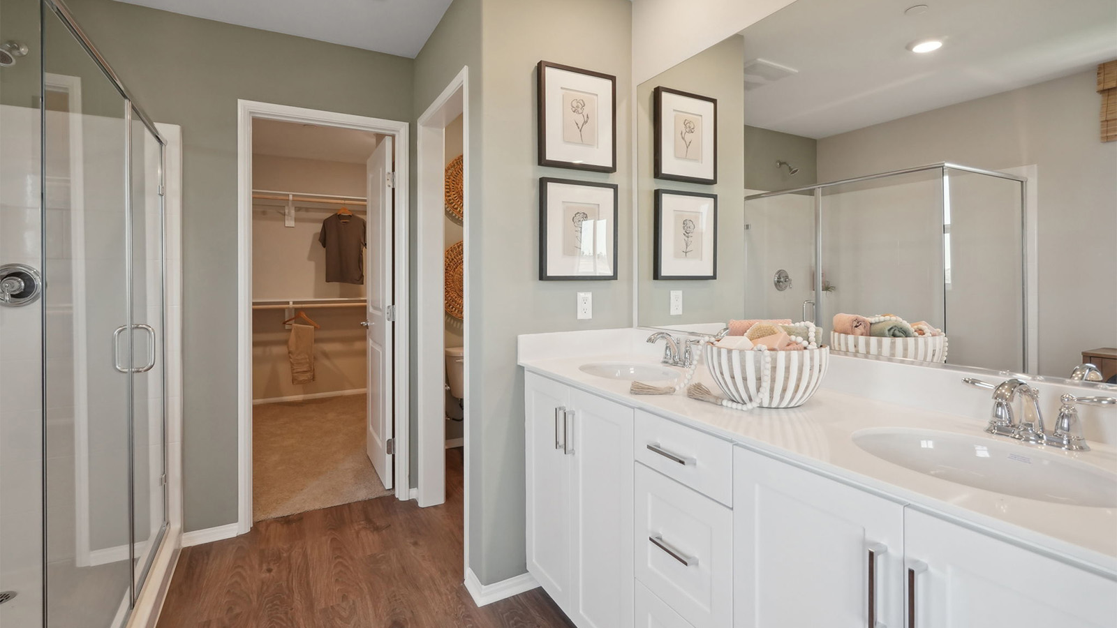 Primary bathroom with dual vanities and shower