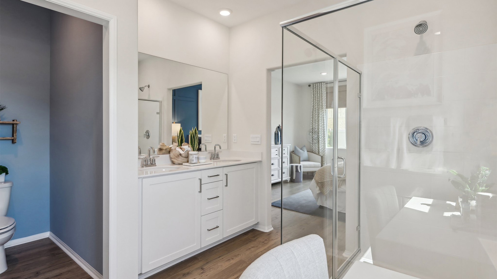 Primary bathroom with dual vanities and shower