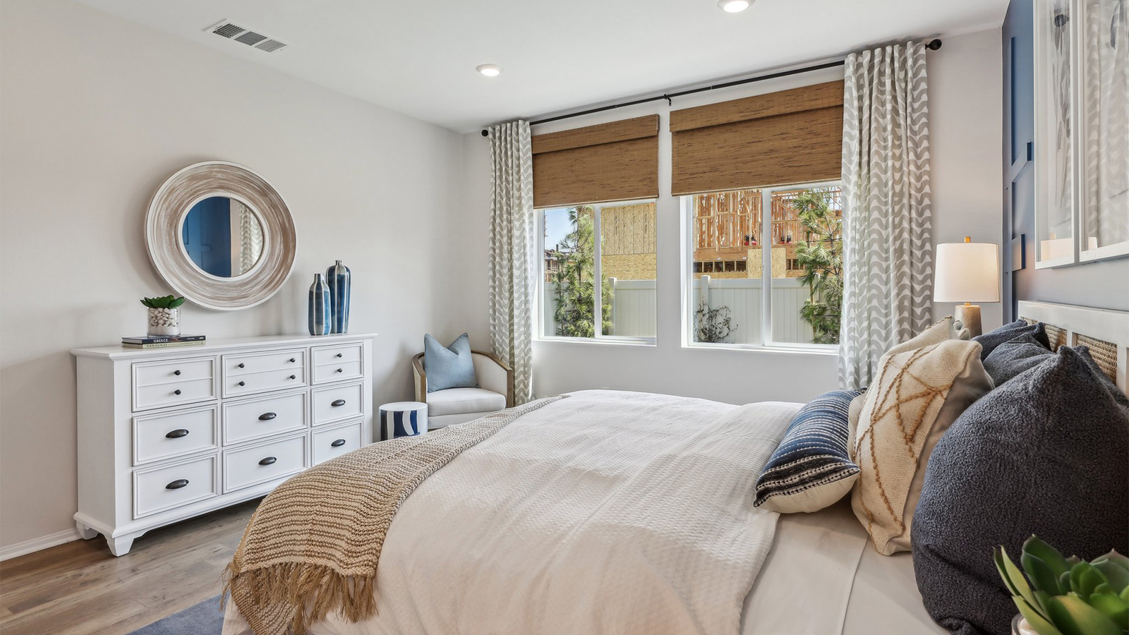 Primary bedroom with king bed and laminate flooring