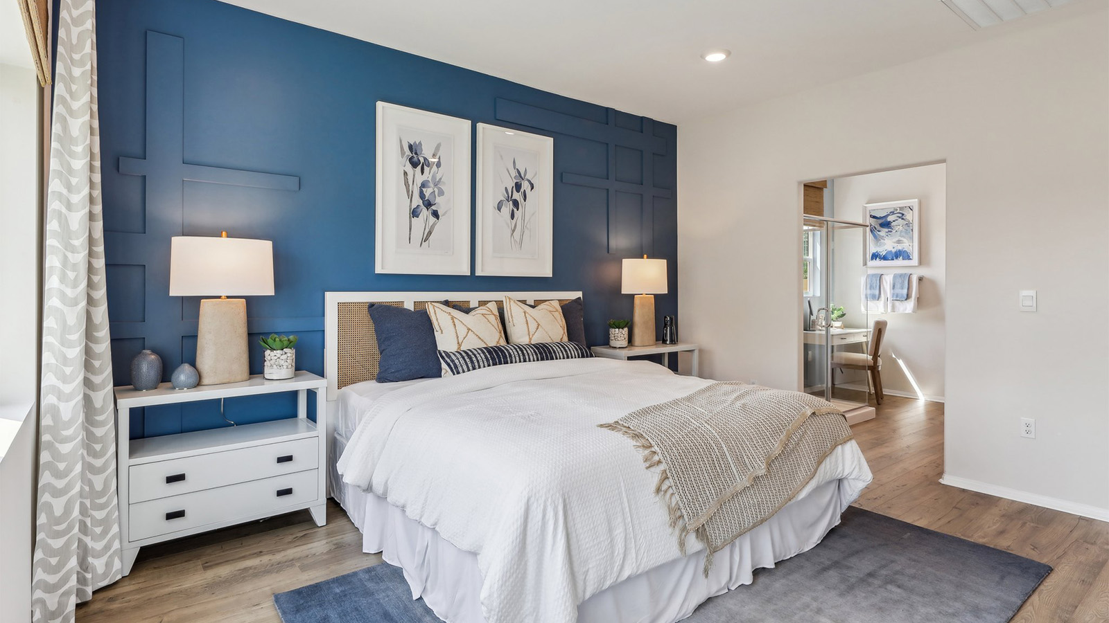 Primary bedroom with king bed and laminate flooring