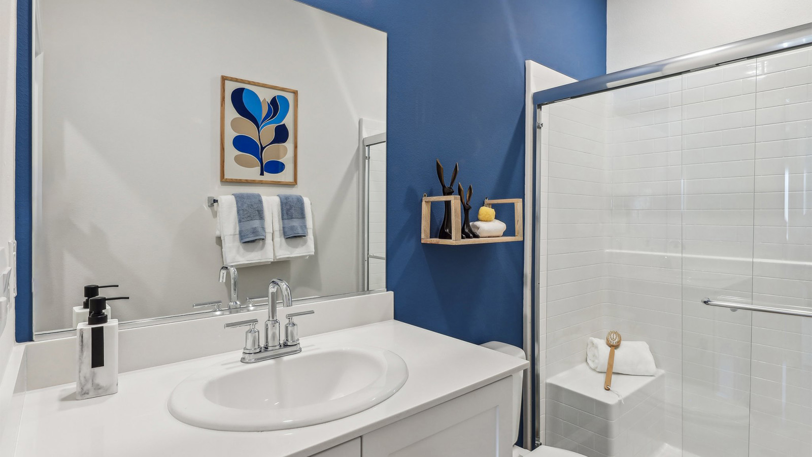 Secondary bathroom with vanity and shower